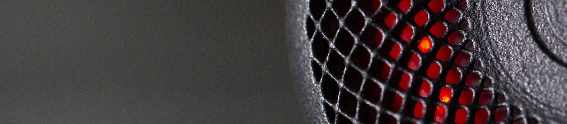 Close-up of a 3D printed bike light housing glowing red | © EOS
